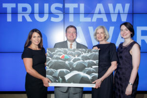 Serena Grant, Director of TrustLaw, (on left) presents the award to Mike Ziri of Equality Illinois and Marjorie Lindblom and Seirian Thomas of Kirkland & Ellis